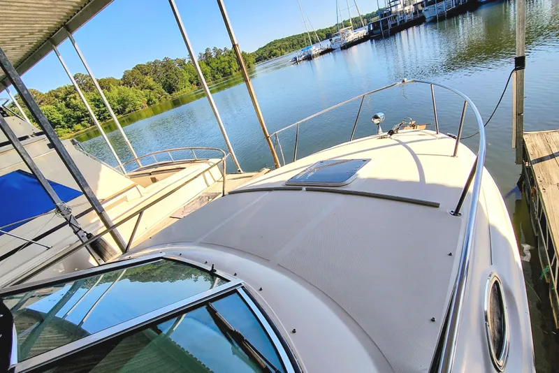 Slide: The Image of 2001 Sea Ray Sundancer 260 docked by calm waters. - 8