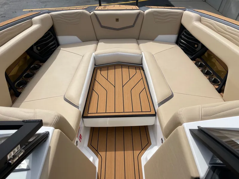 Slide: The Image of 2026 Nautique G25 interior with luxurious seating and wood flooring. - 11