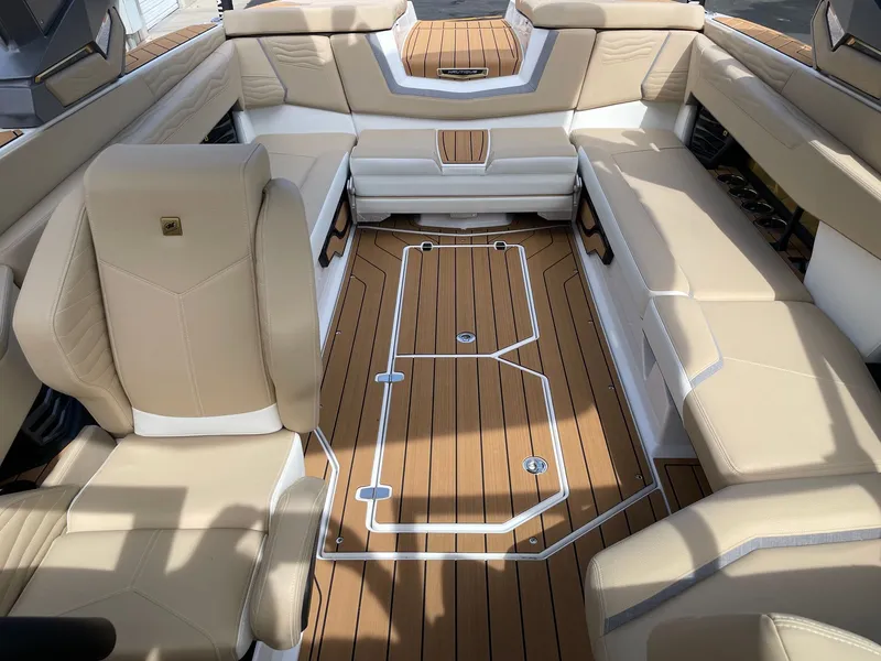 Slide: The Image of 2026 Nautique G25 interior with luxurious seating and wooden flooring. - 12