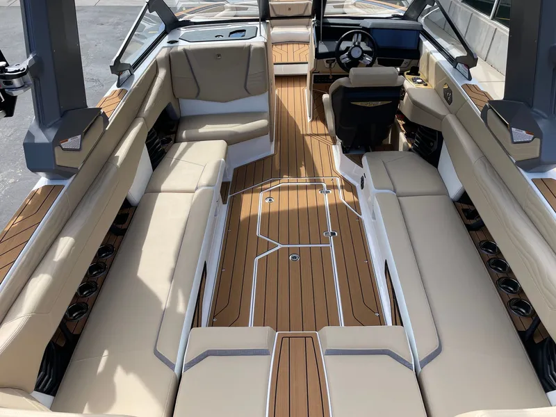 Slide: The Image of Interior of 2026 Nautique G25 with luxurious seating and wood accents. - 5