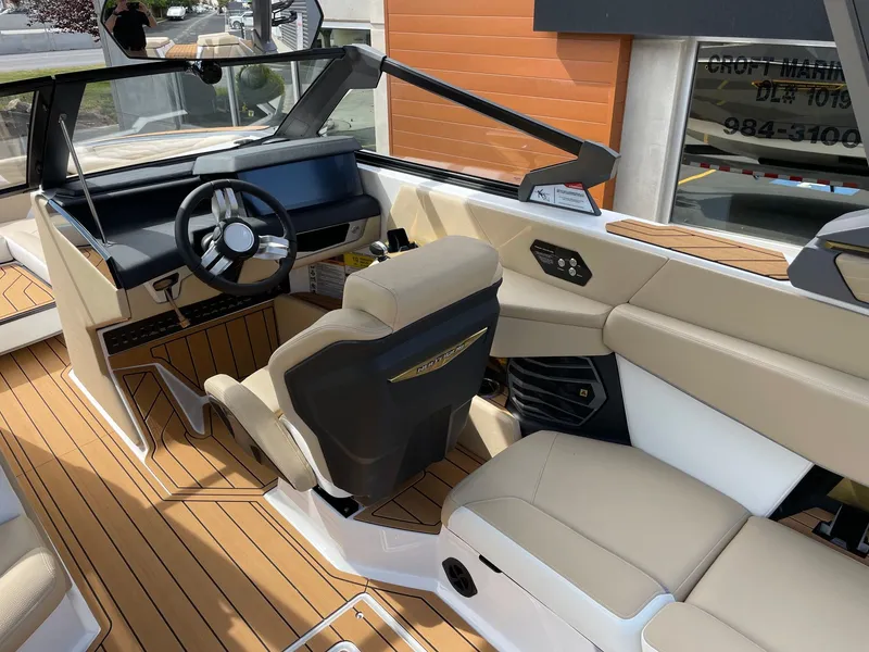 Slide: The Image of Interior of 2026 Nautique G25 with modern steering wheel and seating. - 6