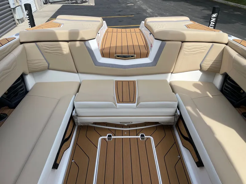 Slide: The Image of 2026 Nautique G25 interior with luxurious seating and wood flooring. - 8