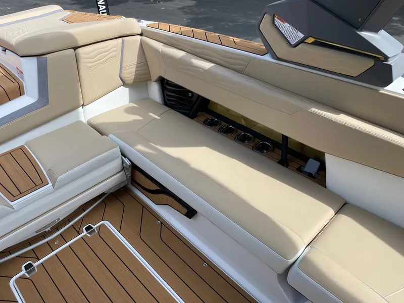 Slide: The Image of 2026 Nautique G25 interior with beige seating and wood accents. - 9