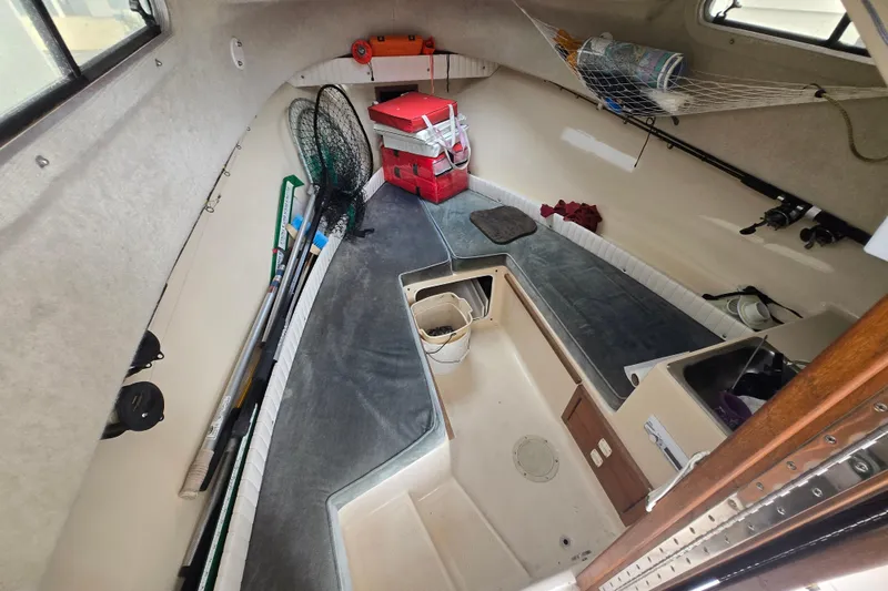 Slide: The Image of Interior of a 1989 Sea Ox 250C boat with fishing gear and storage. - 10