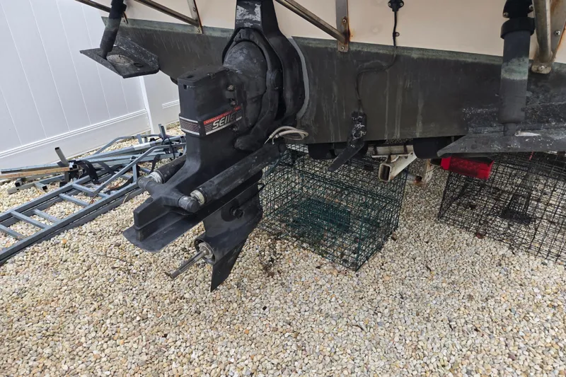 Slide: The Image of Rear view of a 1989 Sea Ox 250C boat with outboard motor on gravel. - 17