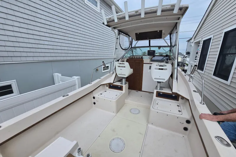 Slide: The Image of 1989 Sea Ox 250C boat interior with dual seats and steering console. - 2