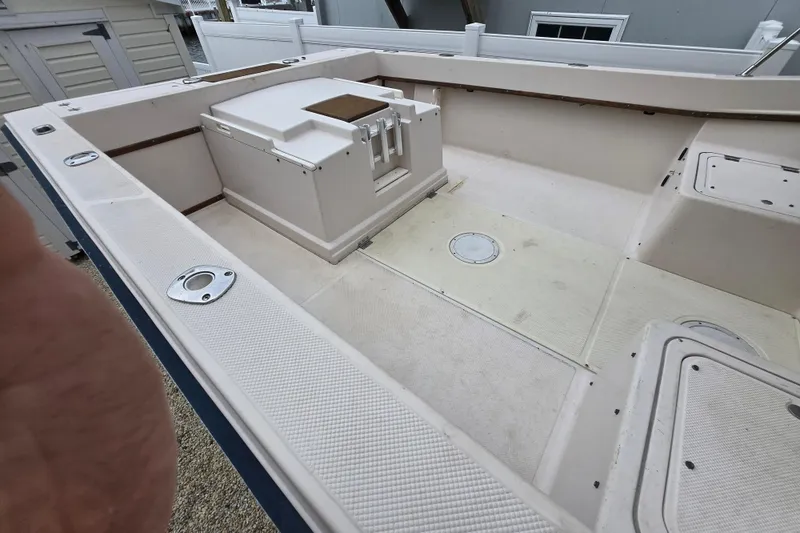 Slide: The Image of 1989 Sea Ox 250C boat interior, featuring spacious deck and storage compartments. - 3