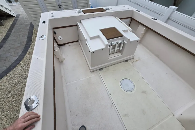 Slide: The Image of 1989 Sea Ox 250C boat interior, featuring a spacious deck and storage compartments. - 6
