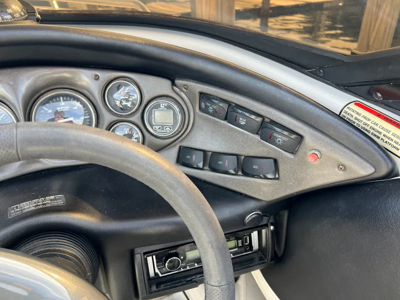 Slide: The Image of Dashboard of a 2003 Crownline 225 LPX boat with instruments. - 13