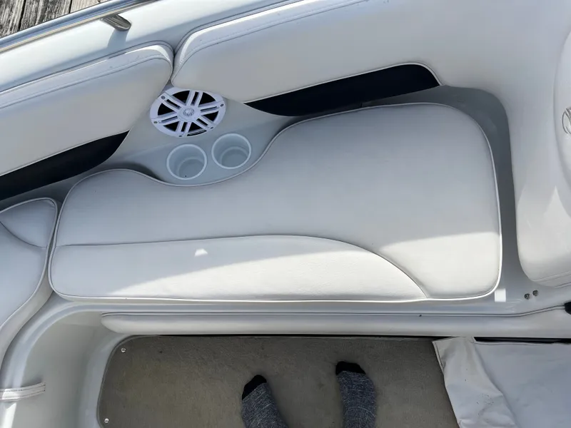 Slide: The Image of Interior of a 2003 Crownline 225 LPX boat with speaker and cup holders. - 21