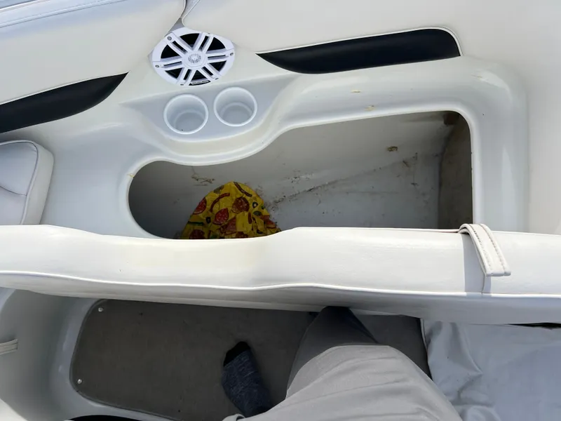 Slide: The Image of Interior of a 2003 Crownline 225 LPX boat with speaker and storage area. - 22