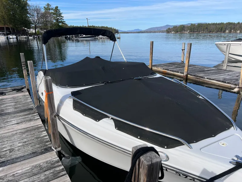 Slide: The Image of 2003 Crownline 225 LPX boat docked on a serene lake. - 24