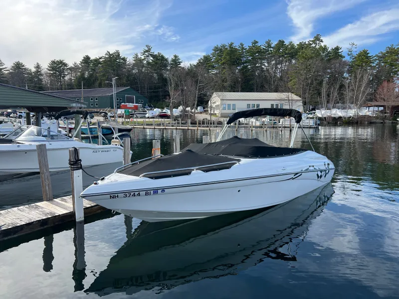 Slide: The Image of 2003 Crownline 225 LPX boat docked, calm water, wooded background. - 25