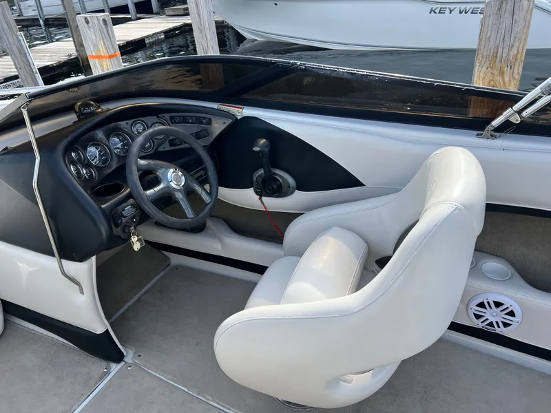 Slide: The Image of Interior of a 2003 Crownline 225 LPX boat with steering console. - 9