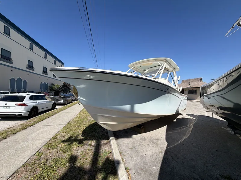 Slide: The Image of 2022 Grady-White Freedom 275 boat on a parking lot. - 17