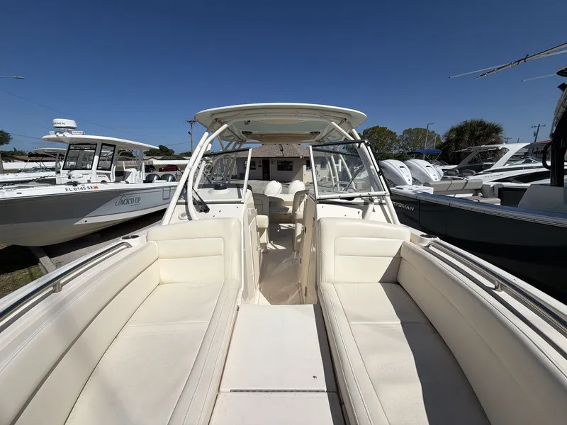 Slide: The Image of 2022 Grady-White Freedom 275 boat with white interior outdoors. - 21