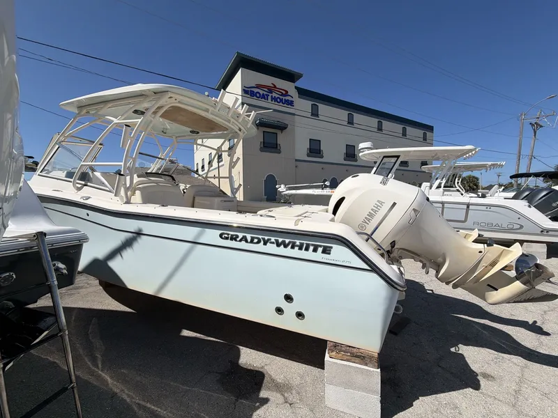 Slide: The Image of 2022 Grady-White Freedom 275 boat in front of a building. - 4