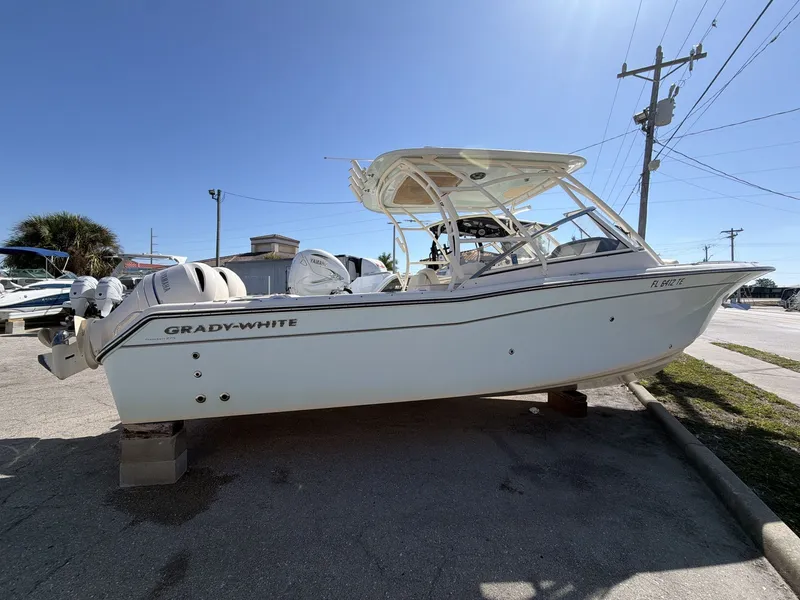 Slide: The Image of 2022 Grady-White Freedom 275 boat on a parking lot. - 8