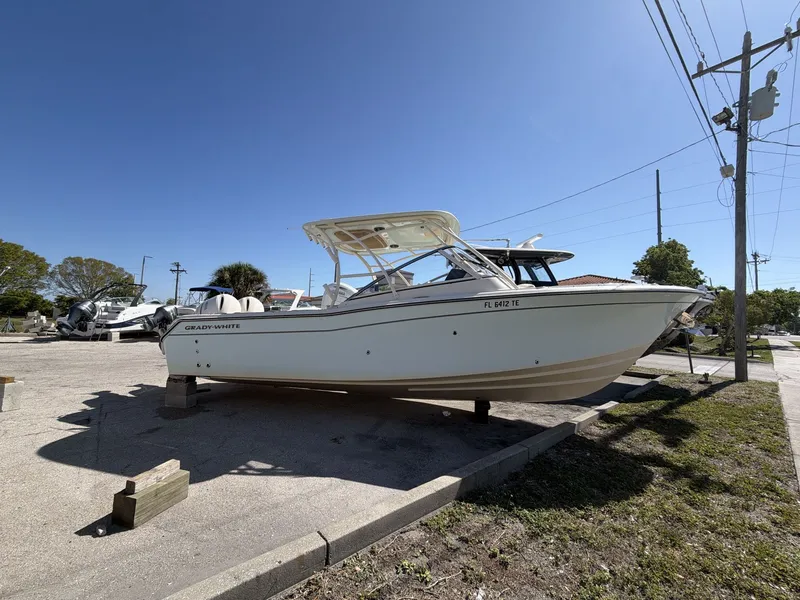 Slide: The Image of 2022 Grady-White Freedom 275 boat on a parking lot. - 9