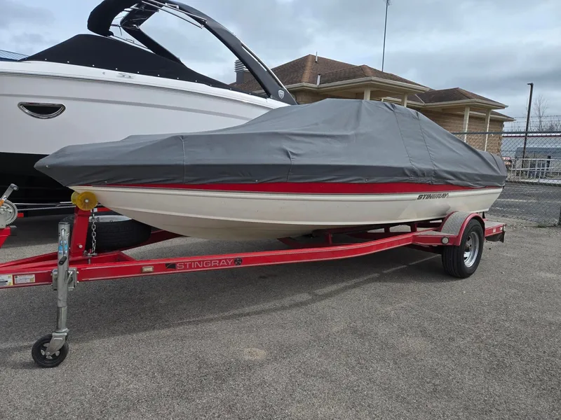 The Image of Covered 2007 Stingray 185 boat on red trailer. - 1