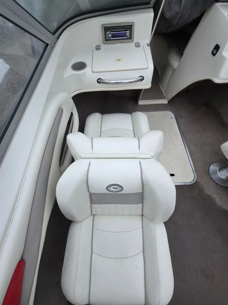 Slide: The Image of Interior of a 2007 Stingray 185 boat with white seating. - 5