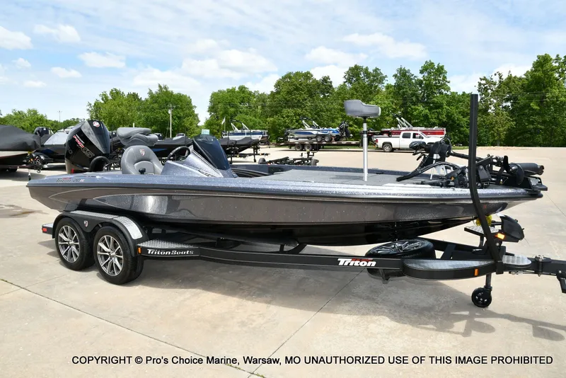 The Image of 2024 Triton 20XP Patriot boat on trailer outdoors. - 1