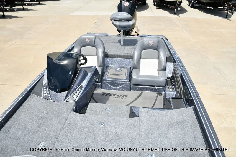 Slide: The Image of 2024 Triton 20XP Patriot boat with gray seats and steering console. - 13