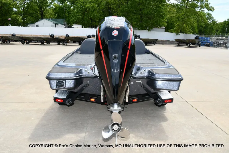 Slide: The Image of Rear view of 2024 Triton 20XP Patriot boat on a parking lot. - 27
