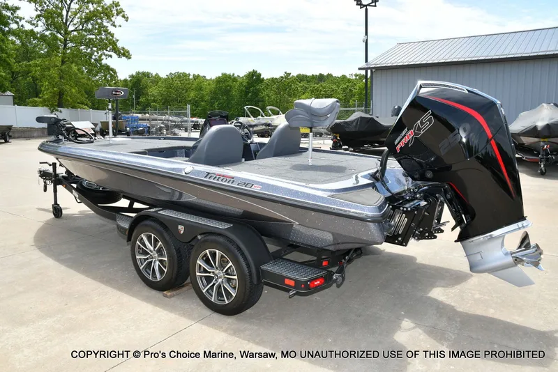 Slide: The Image of 2024 Triton 20XP Patriot boat on trailer outdoors. - 28
