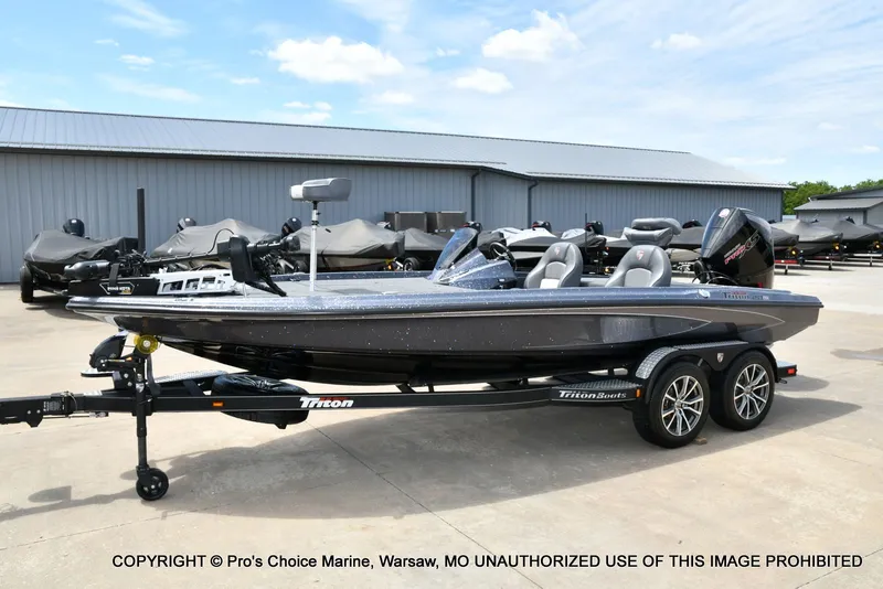 Slide: The Image of 2024 Triton 20XP Patriot boat on trailer outdoors. - 30