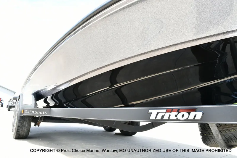 Slide: The Image of 2024 Triton 20XP Patriot boat on trailer, close-up view. - 36
