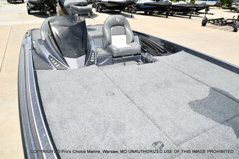 Slide: The Image of 2024 Triton 20XP Patriot boat with gray deck and seat. - 39