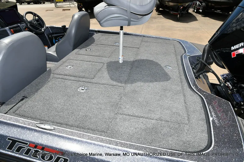 Slide: The Image of 2024 Triton 20XP Patriot boat with gray carpeted deck. - 44