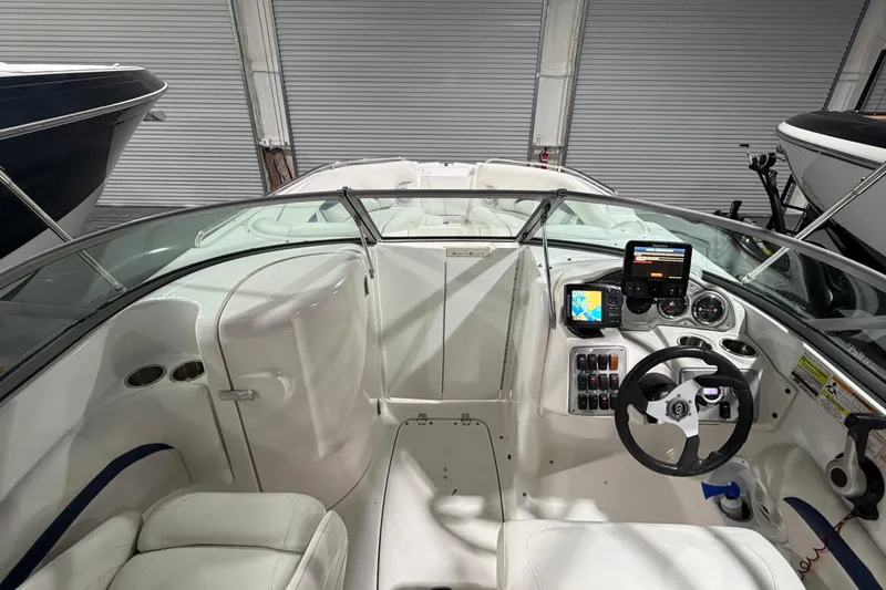 Slide: The Image of 2013 Hurricane SunDeck 2400 OB boat on trailer in storage facility. - 12