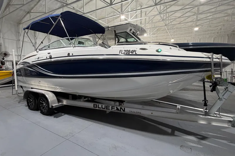 Slide: The Image of 2013 Hurricane SunDeck 2400 OB boat with Yamaha 250 engine in storage facility. - 2