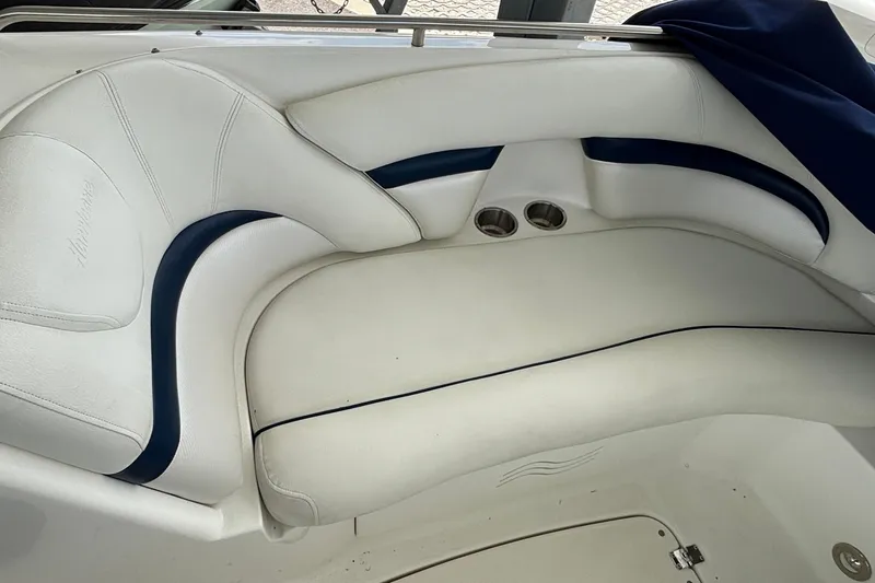 Slide: The Image of 2013 Hurricane SunDeck 2400 OB boat interior with white and blue seating. - 22