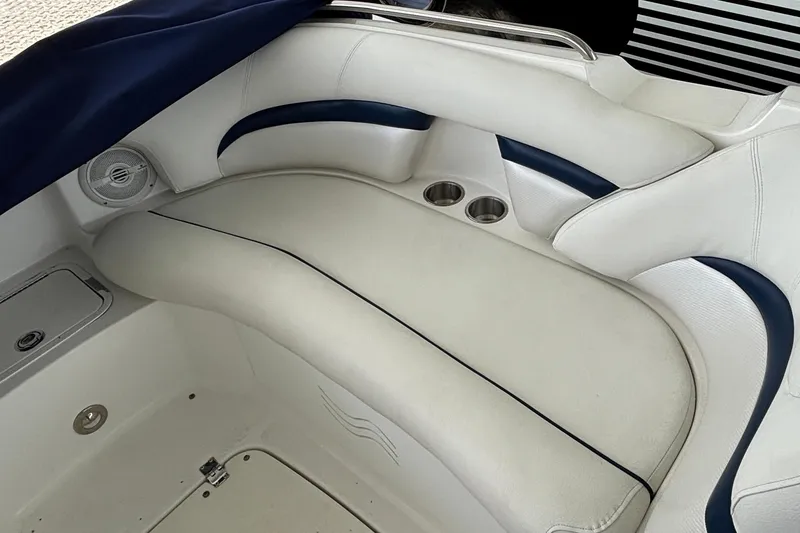 Slide: The Image of 2013 Hurricane SunDeck 2400 OB boat interior with white seating and cup holders. - 23