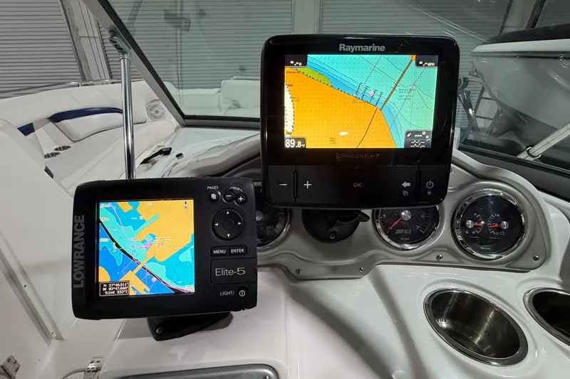 Slide: The Image of Dashboard of a 2013 Hurricane SunDeck 2400 OB with navigation displays and gauges. - 24