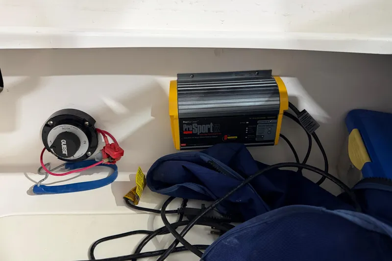 Slide: The Image of Battery switch and charger setup on a 2013 Hurricane SunDeck 2400 OB boat. - 27