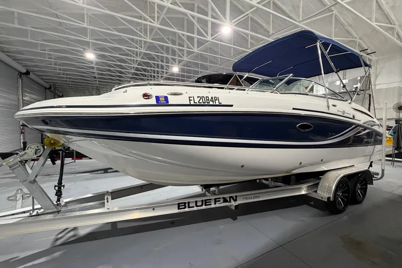 Slide: The Image of 2013 Hurricane SunDeck 2400 OB boat on trailer in indoor storage facility. - 3