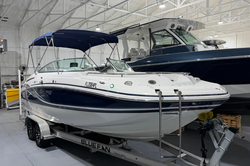Slide: The Image of 2013 Hurricane SunDeck 2400 OB boat on trailer in indoor storage facility. - 4
