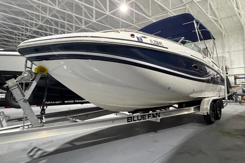 Slide: The Image of 2013 Hurricane SunDeck 2400 OB boat on trailer in indoor storage facility. - 5