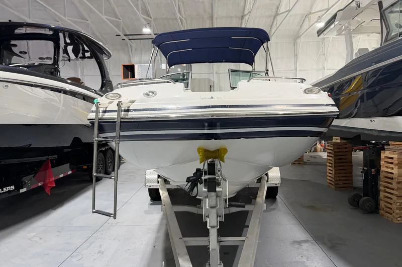 Slide: The Image of 2013 Hurricane SunDeck 2400 OB boat on Blue Fin trailer in indoor storage. - 6