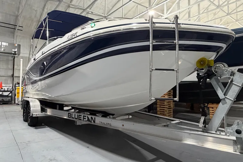 Slide: The Image of 2013 Hurricane SunDeck 2400 OB boat on trailer in indoor storage facility. - 8
