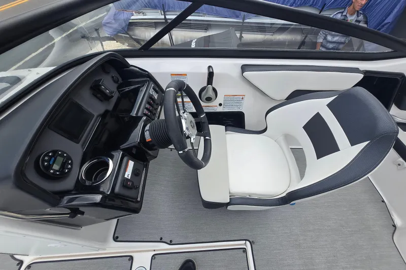 Slide: The Image of 2021 Yamaha Boats AR195 cockpit with steering wheel and control panel. - 12