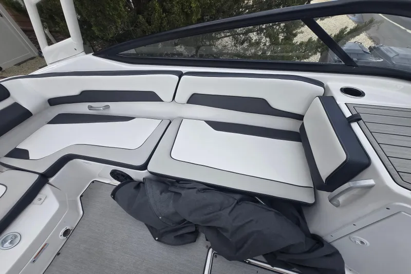 Slide: The Image of 2021 Yamaha Boats AR195 interior seating with sleek white and black design. - 13