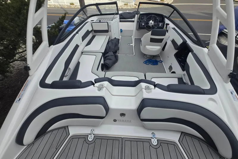 Slide: The Image of 2021 Yamaha Boats AR195 interior with sleek seating and modern dashboard design. - 2