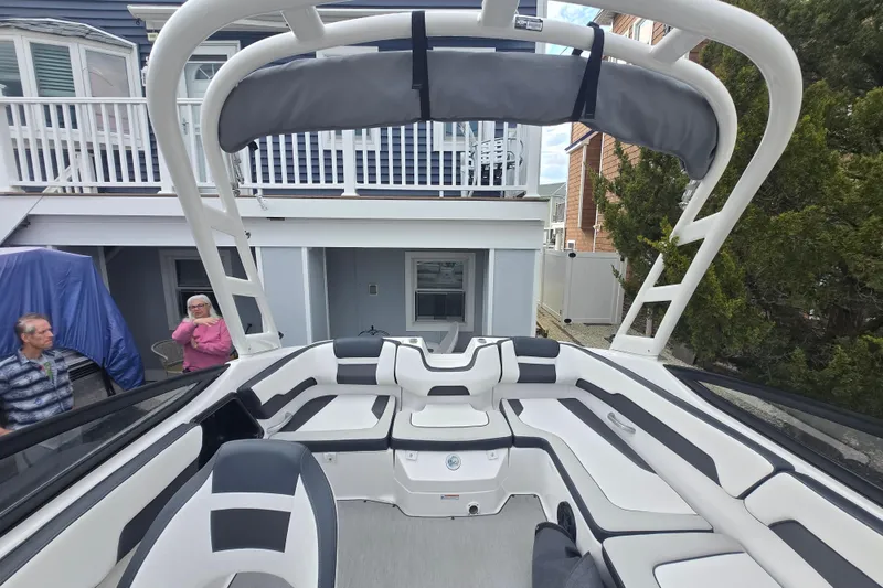 Slide: The Image of 2021 Yamaha Boats AR195 interior with sleek seating and modern design in a residential setting. - 8