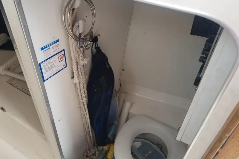 Slide: The Image of 1977 Bertram 28 Moppie boat interior with ropes and marine equipment. - 12