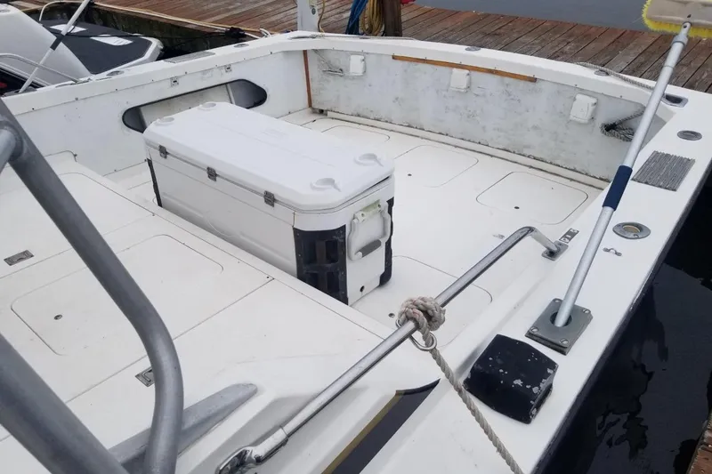 Slide: The Image of 1977 Bertram 28 Moppie boat deck with cooler and docked at marina. - 20